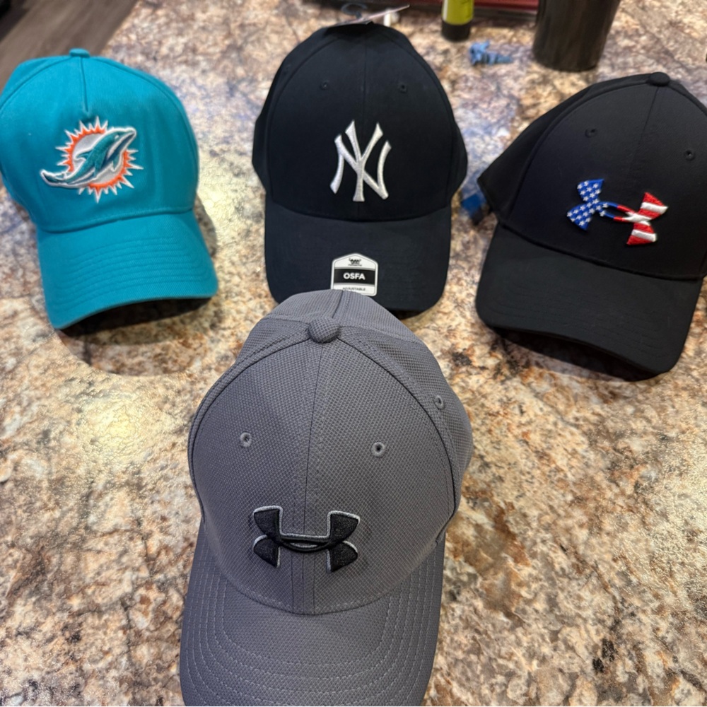 Under Armour Gray Cap and Black Freedom Cap.